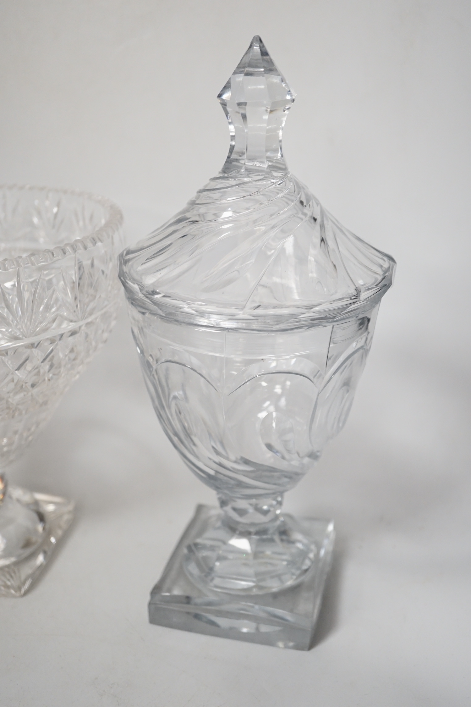 A pair of Regency Irish cut glass sweetmeat vases and covers, 30cm high and an Edwardian cut glass pedestal vase (3)